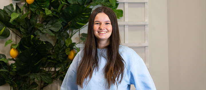 Headshot of a White Stores customer service employee, smiling.