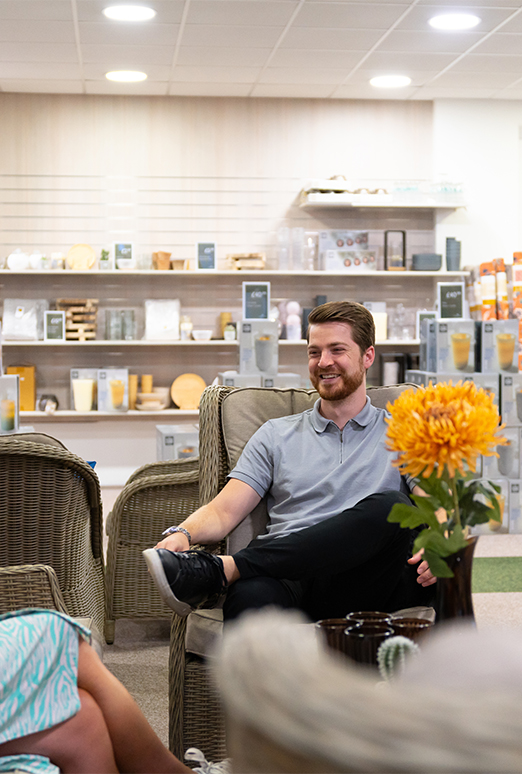 White Stores employees sitting in the showroom having a conversation and smiling